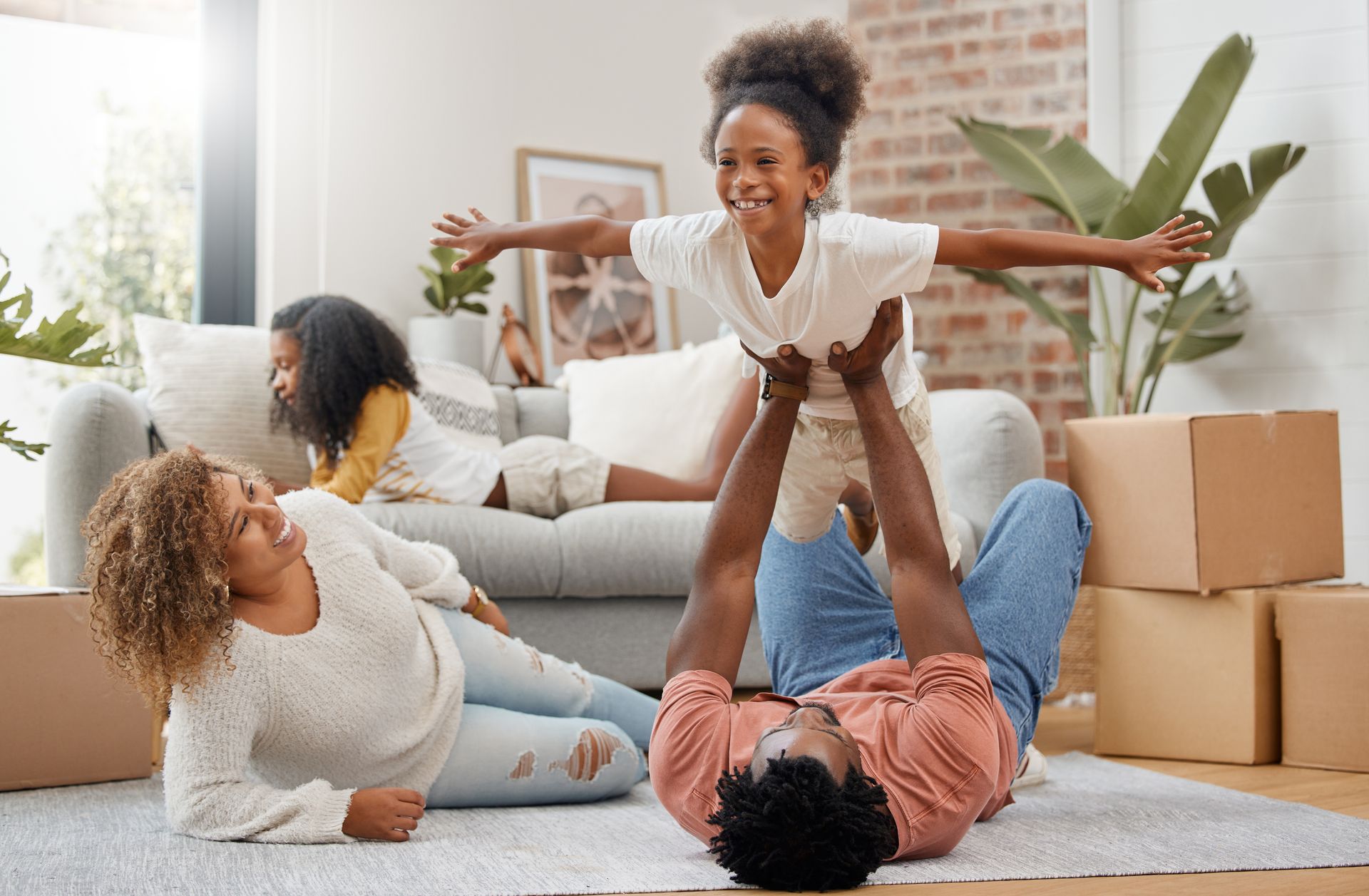 A yellow house with a tree in front of it