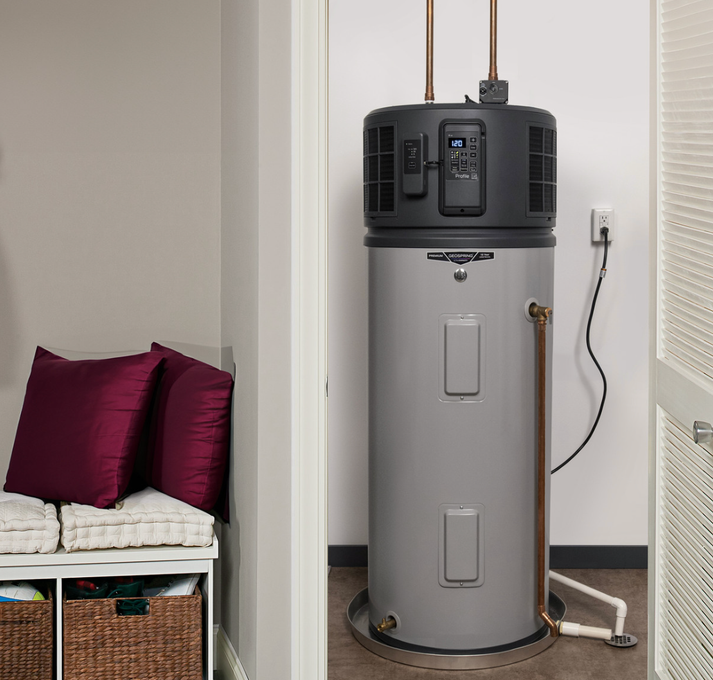 Tall gray water heater in a small utility closet beside a white bench with burgundy pillows.