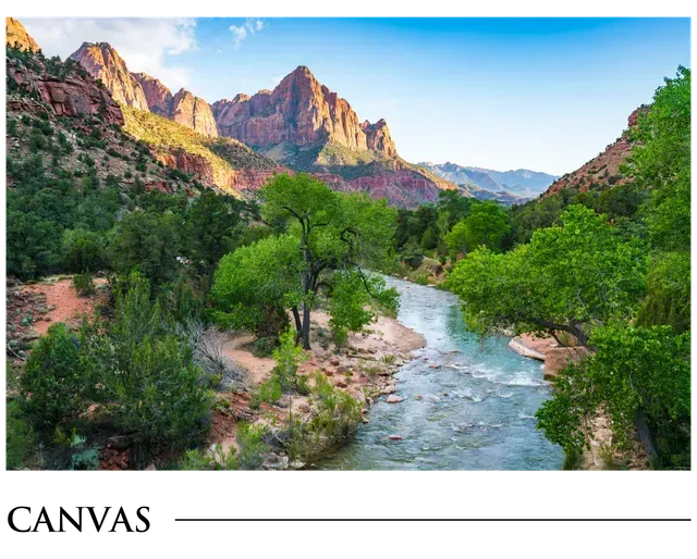 A river flowing through a valley surrounded by mountains and trees.