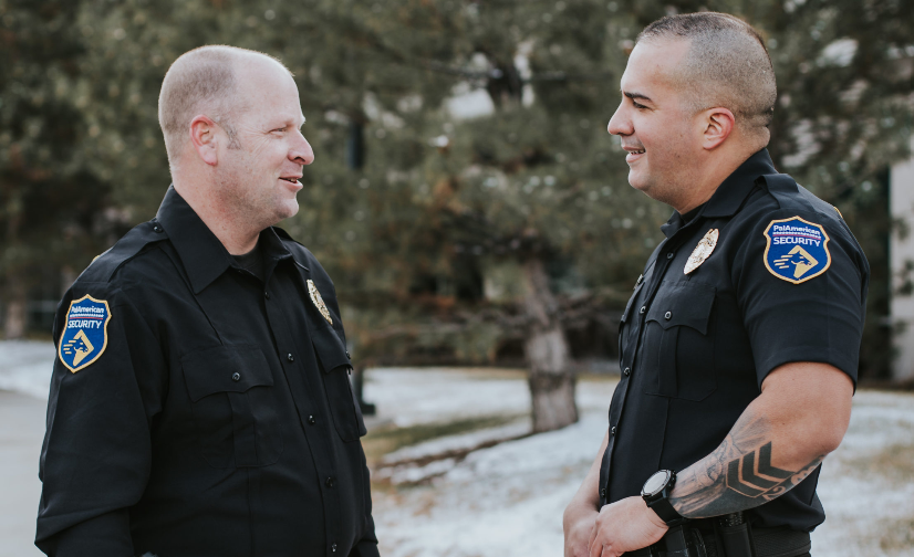 Two police officers are standing next to each other and talking.