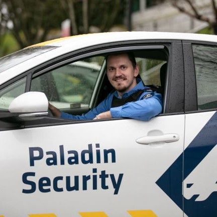 A man is sitting in a paladin security car