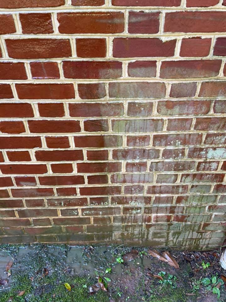 man cleaning terrace with a power washer