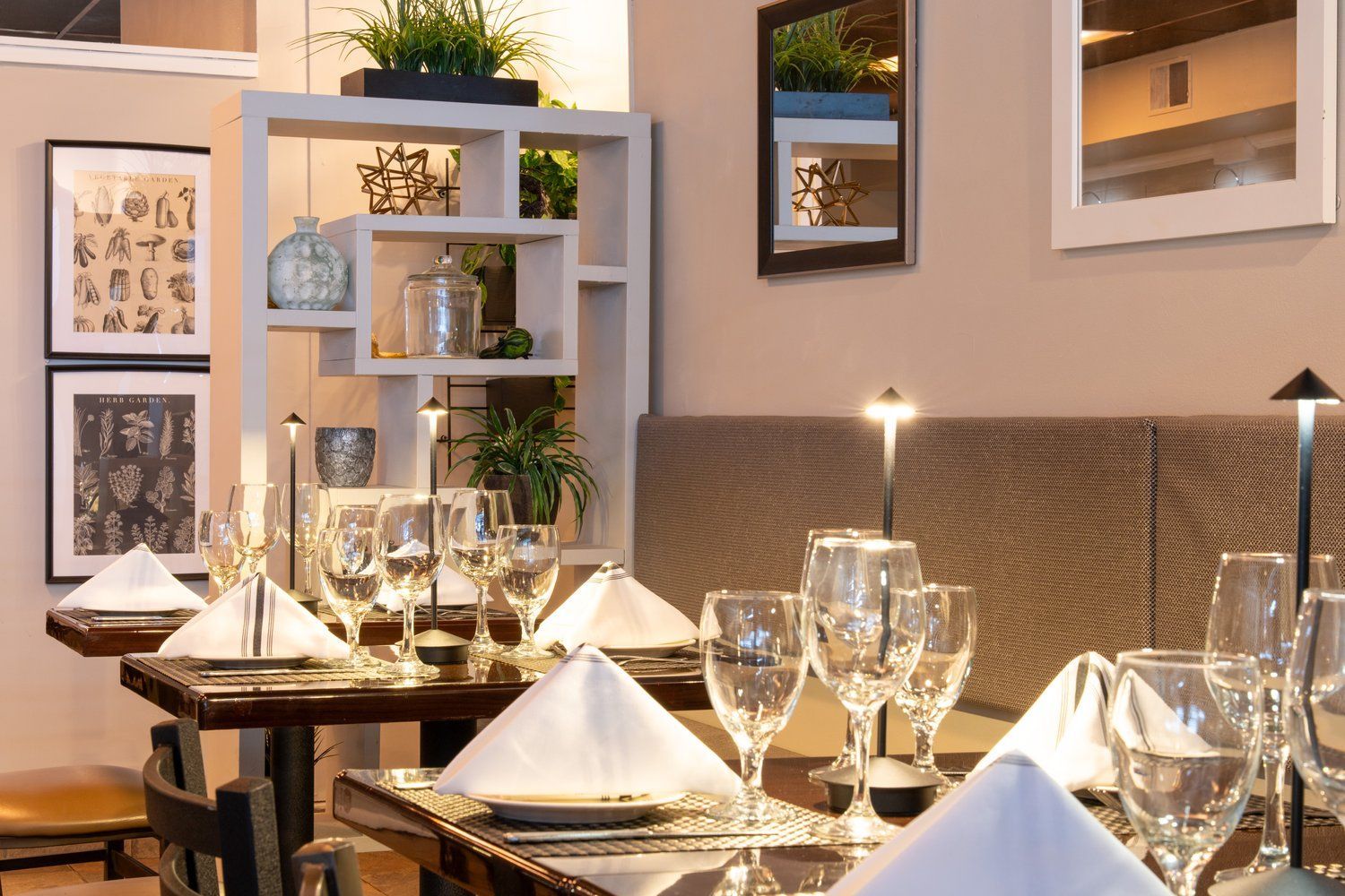 A restaurant with tables and chairs set for a meal