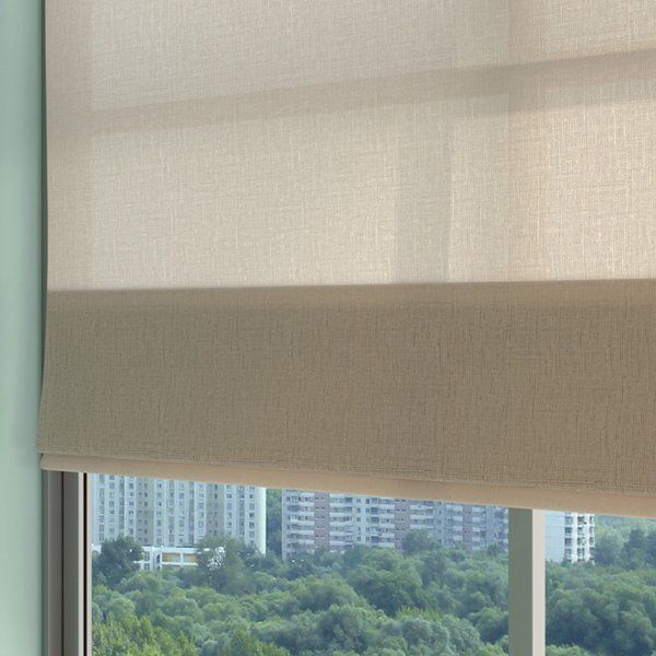 roller blind half drawn over a high-rise window