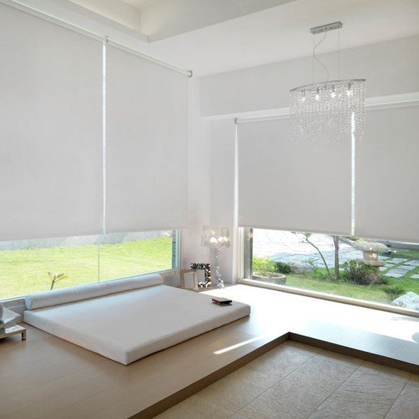 white roller blinds half drawn within a contemporary bedroom