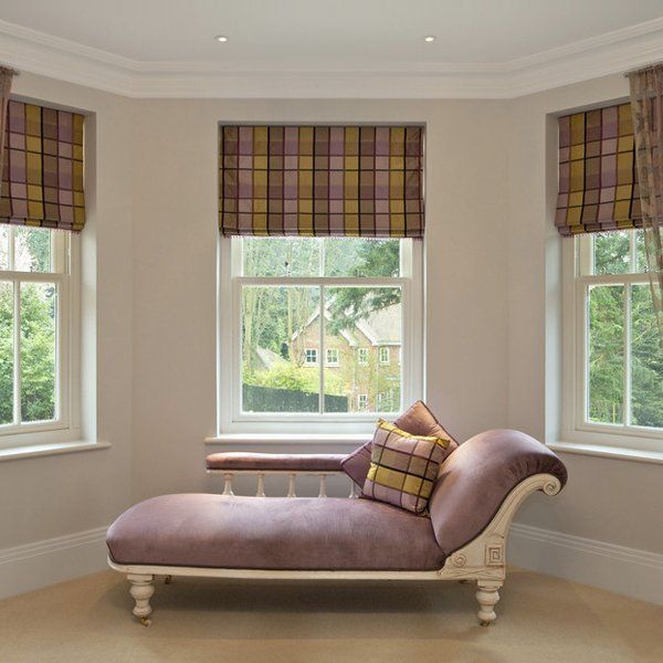 patterned roman blinds over 3 windows in a living space with a chaise lounge