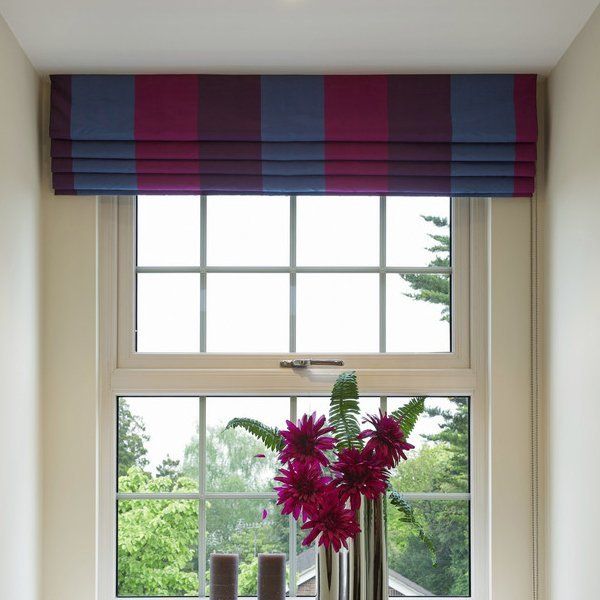 striped patterned roman blind over a window with flowers