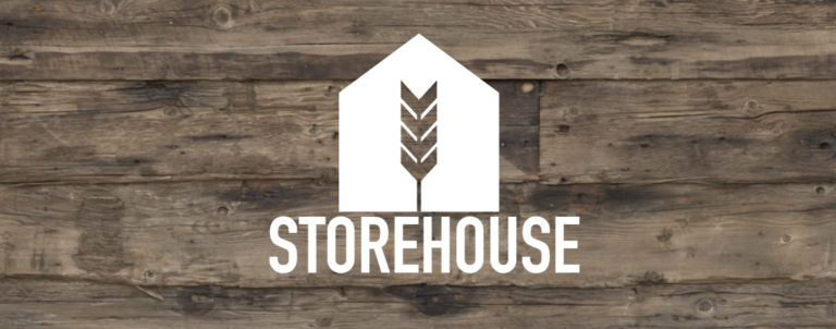 The storehouse logo is on a wooden surface.
