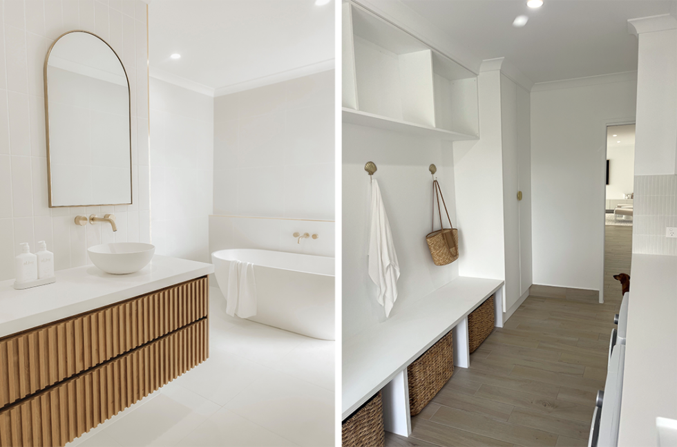 Bright minimalist hallway and vanity with white walls, wood accents, bench, and mirror-lit bathroom area