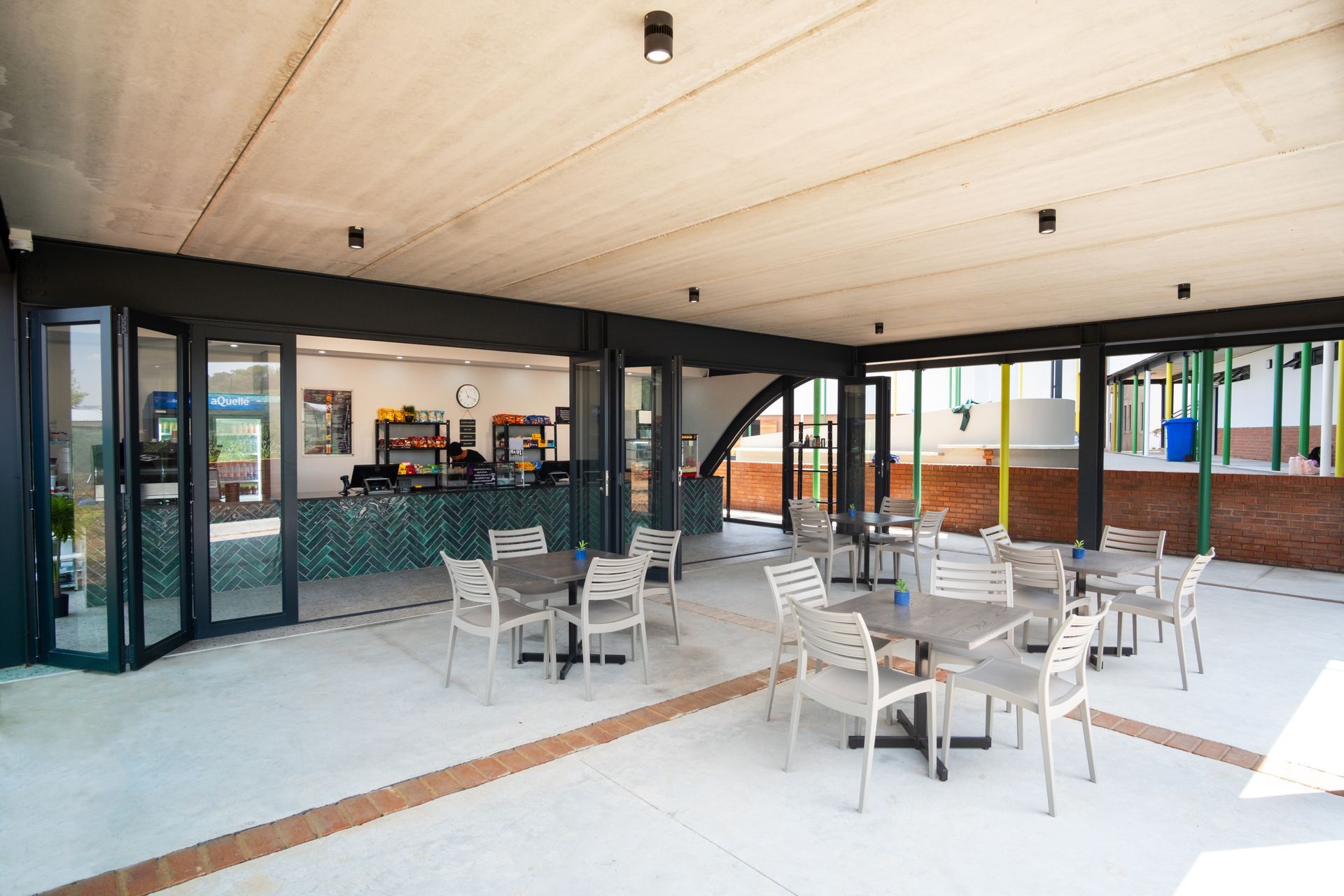 A group of students are sitting at a table in a classroom looking at a model of a molecule.