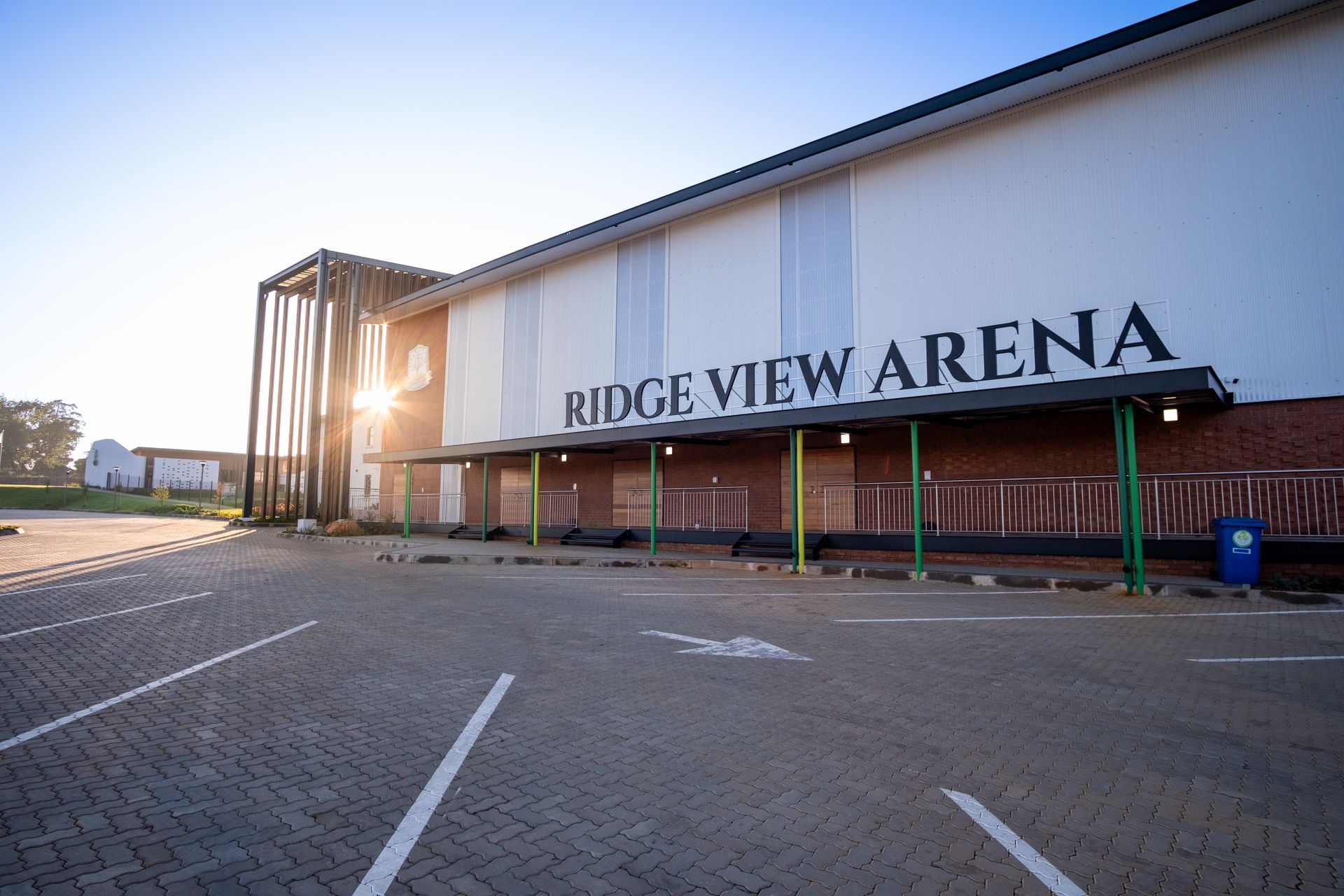 An artist 's impression of a building with cars parked in front of it.