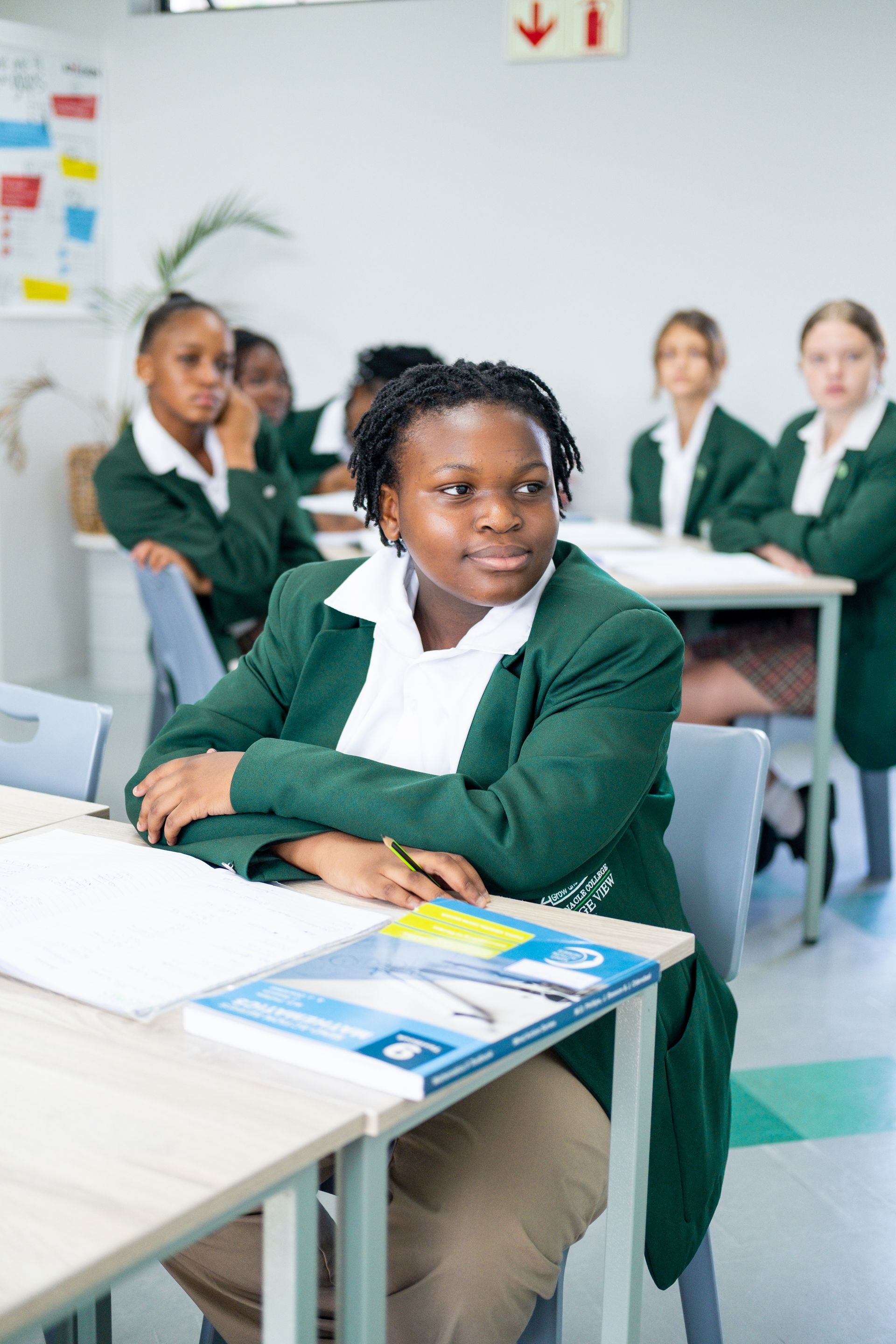 A group of people are standing in front of a large building.