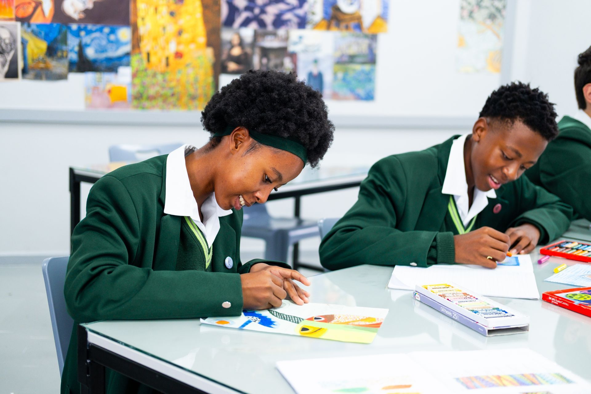 A group of people are sitting on the grass talking to each other.
