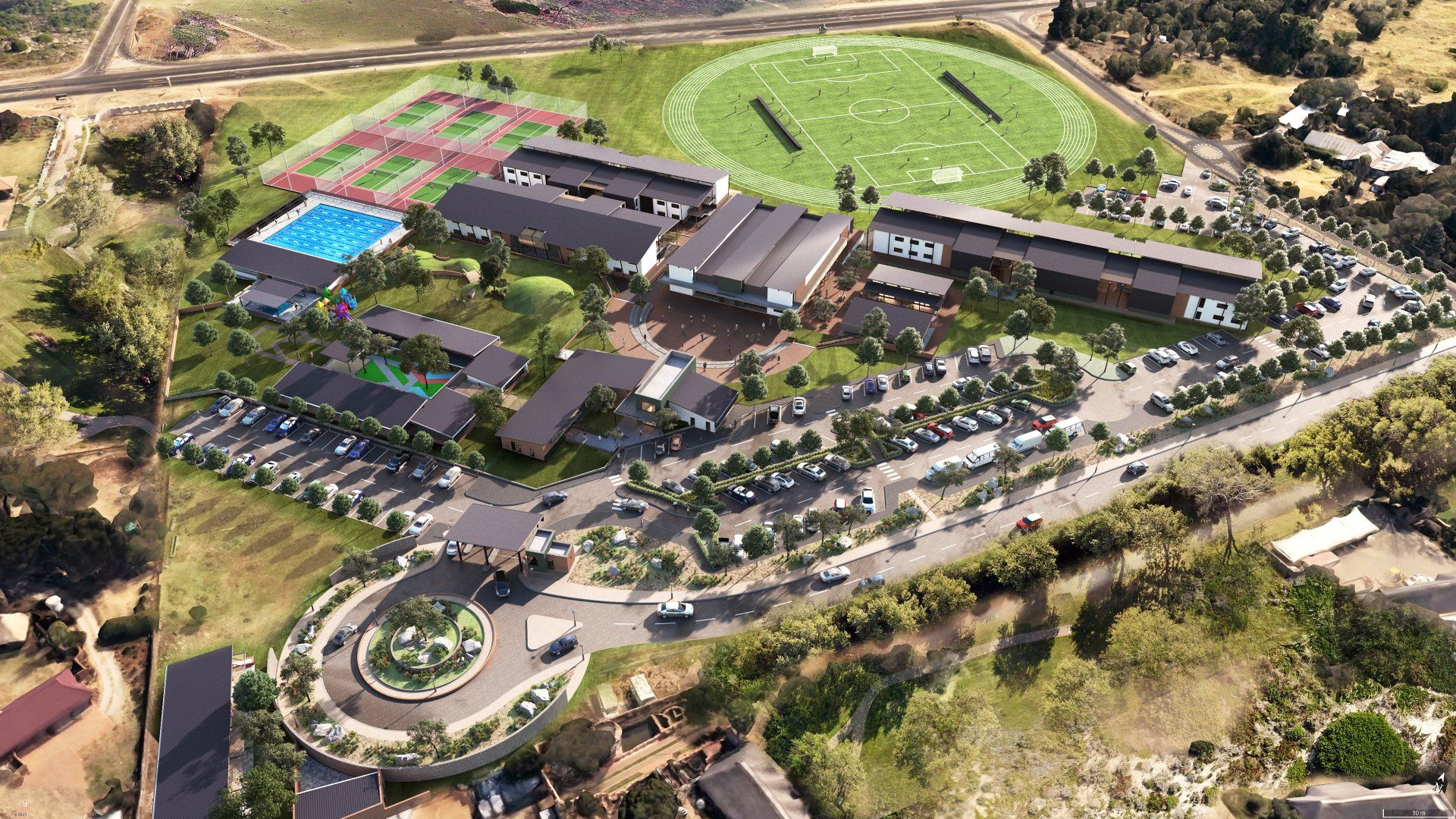 An aerial view of a large building with a soccer field in the middle