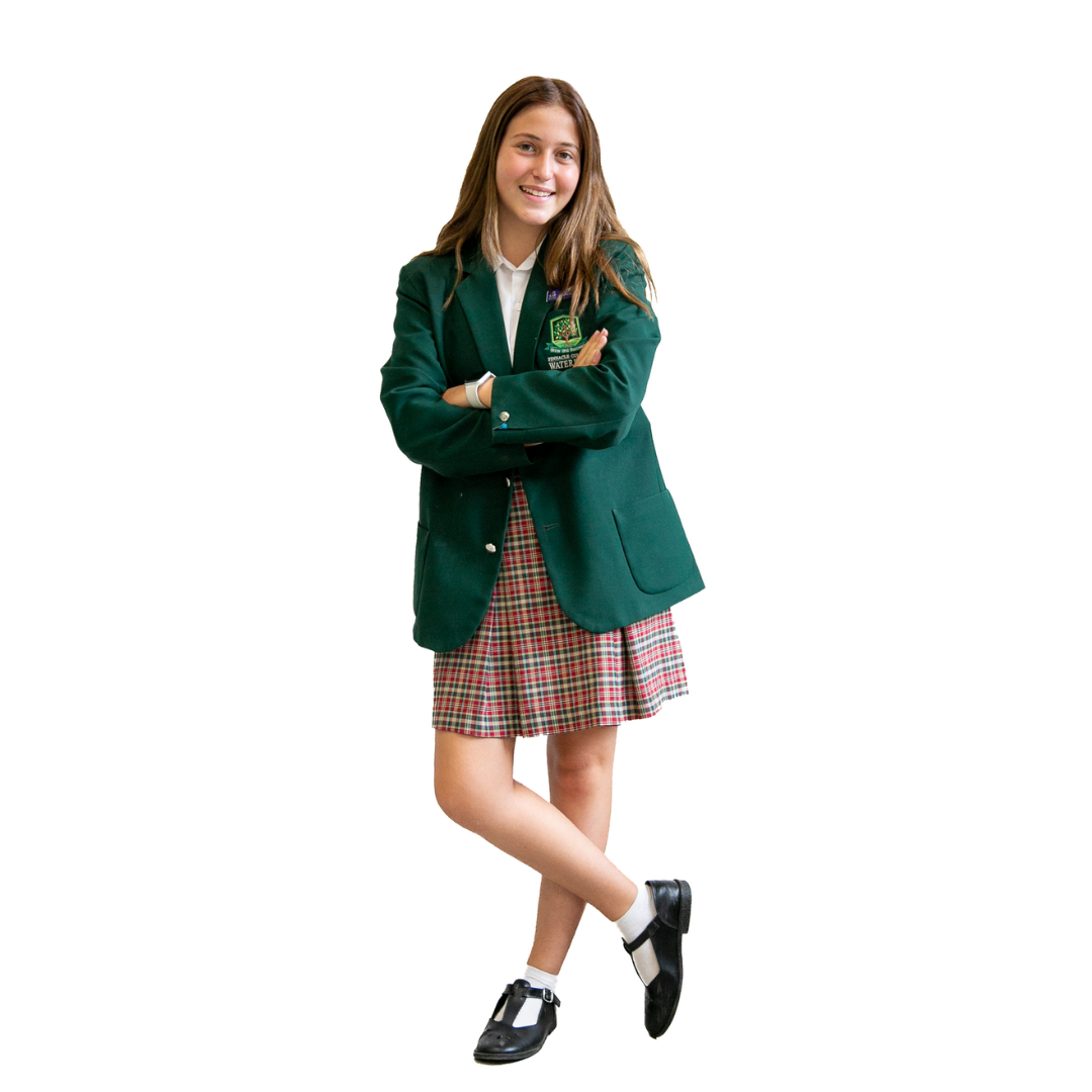A girl in a school uniform is standing with her arms crossed.