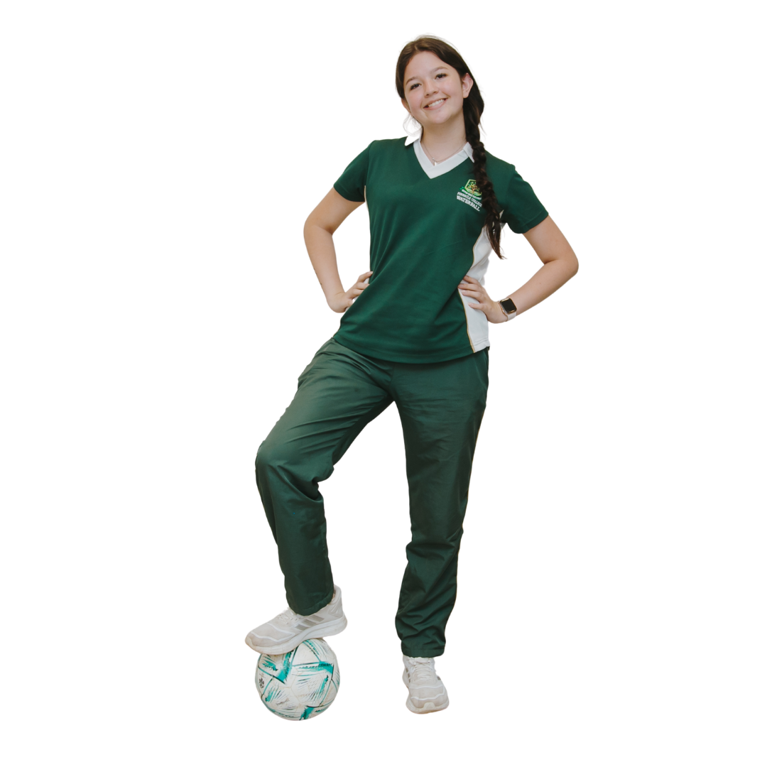 A woman in a green shirt is standing next to a soccer ball