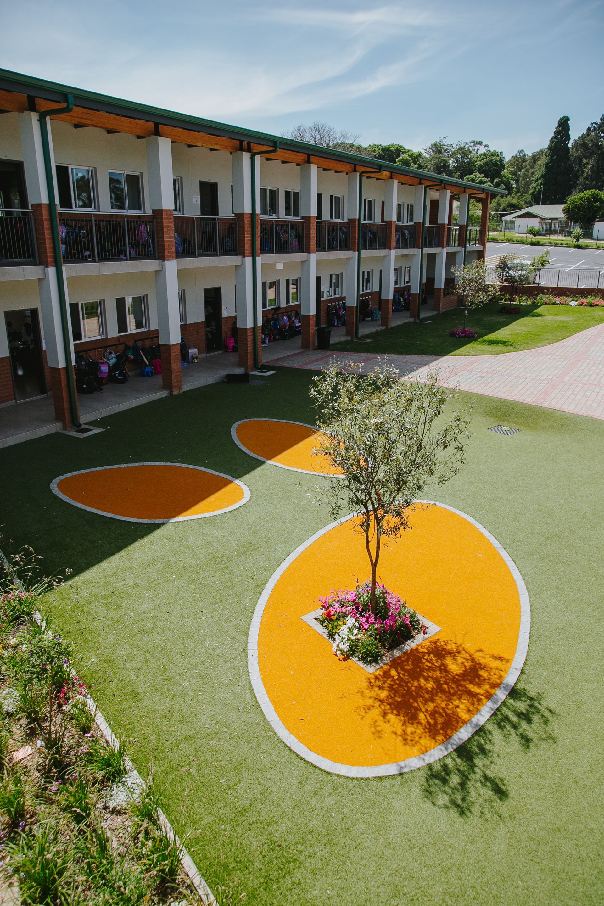 A large building with a tree in the middle of the courtyard.
