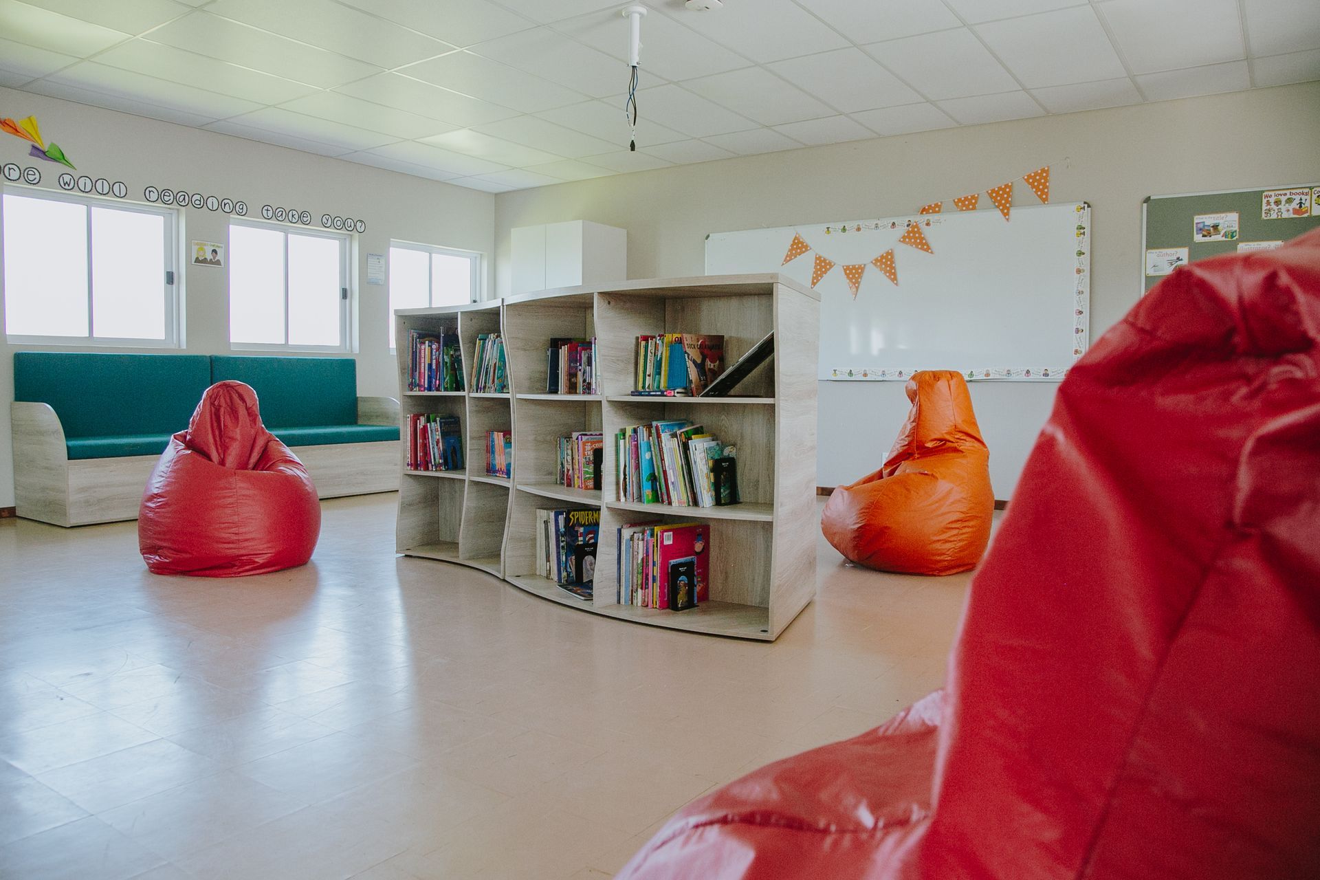 A library with bean bag chairs and shelves filled with books.