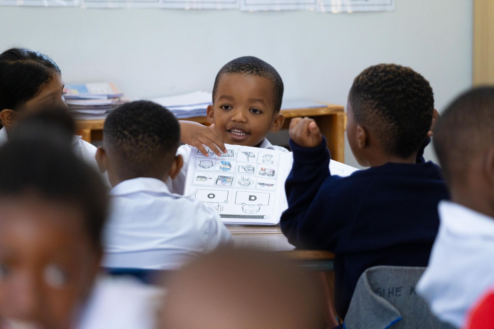 A group of children are sitting at desks in a classroom.