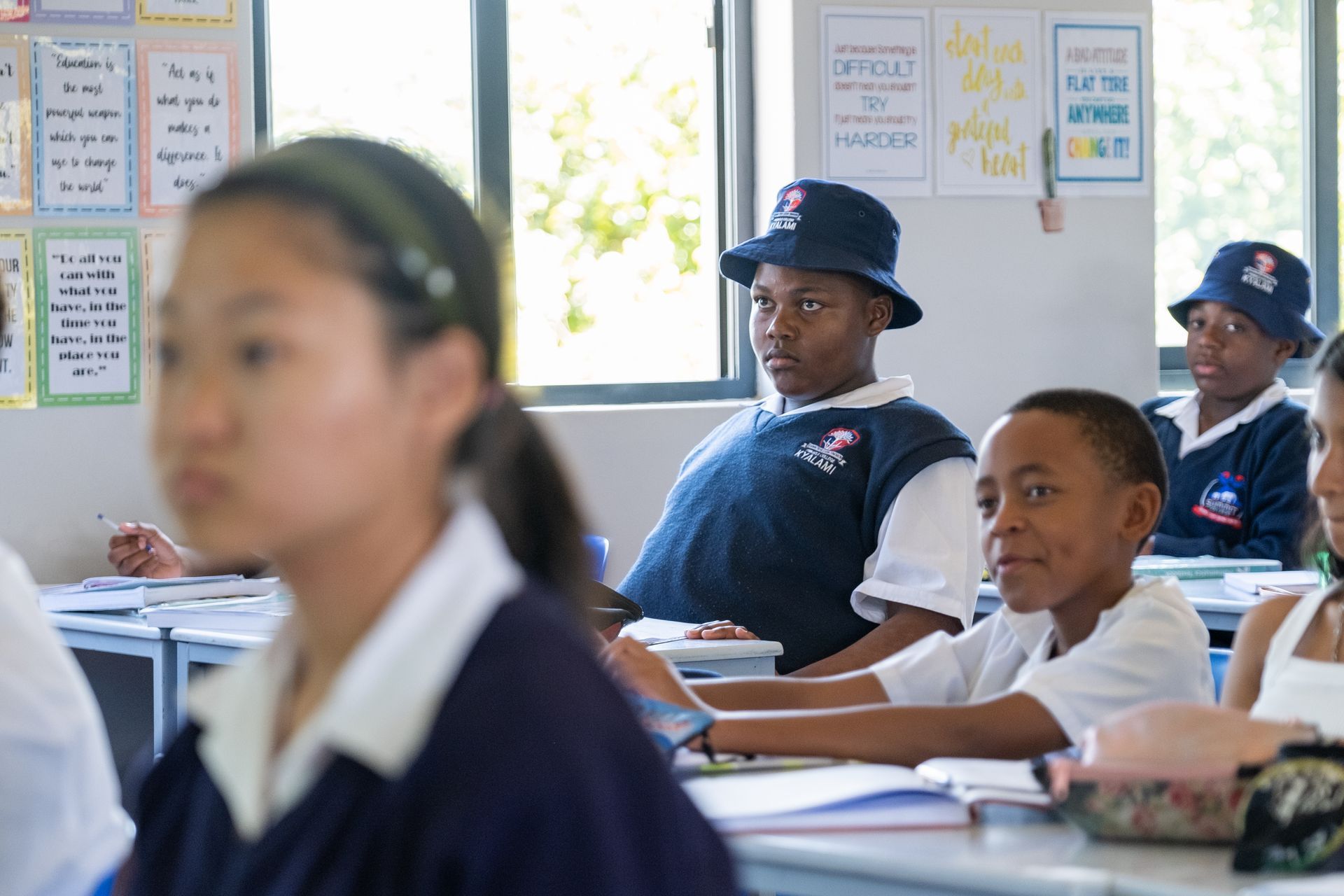 A group of children are sitting at their desks in a classroom.