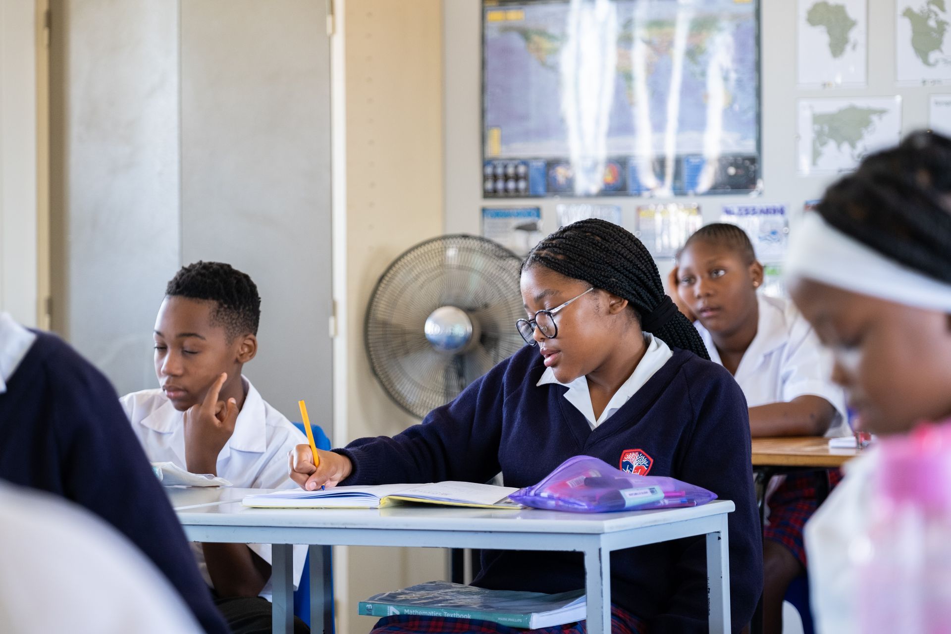A group of children are sitting at desks in a classroom.