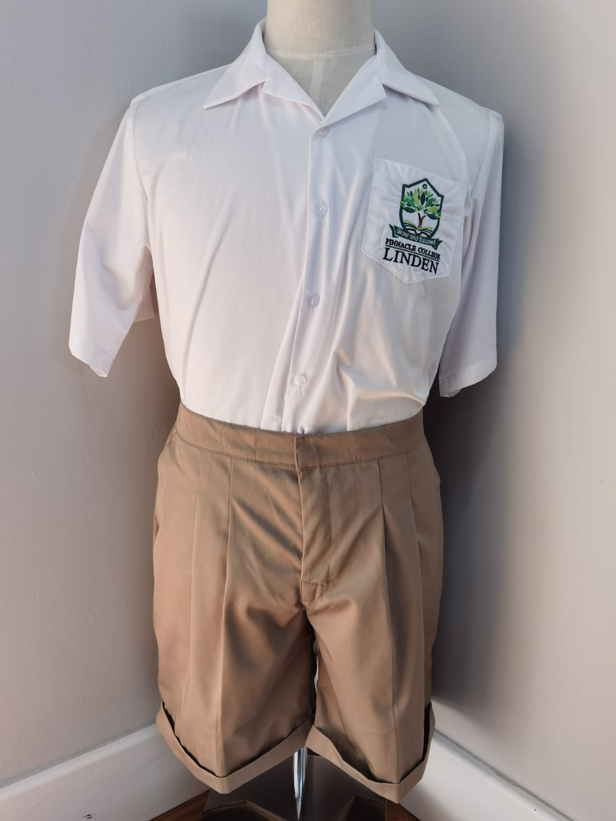 A mannequin is wearing a white shirt and khaki shorts