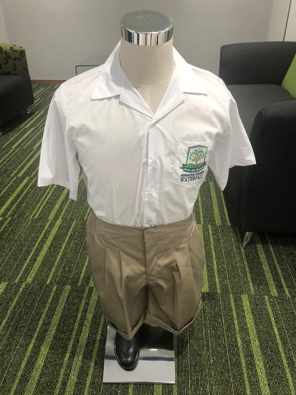 A mannequin is wearing a white shirt and khaki pants.