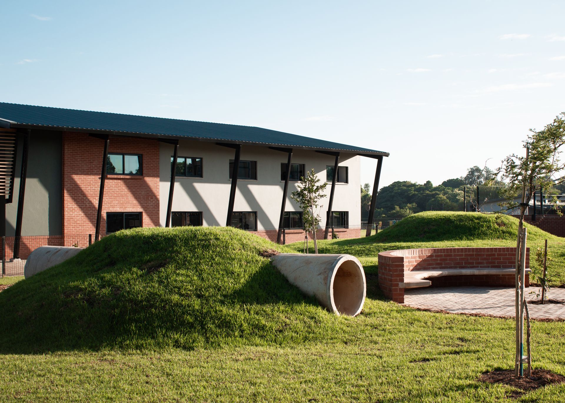 A large building with a lot of grass in front of it.
