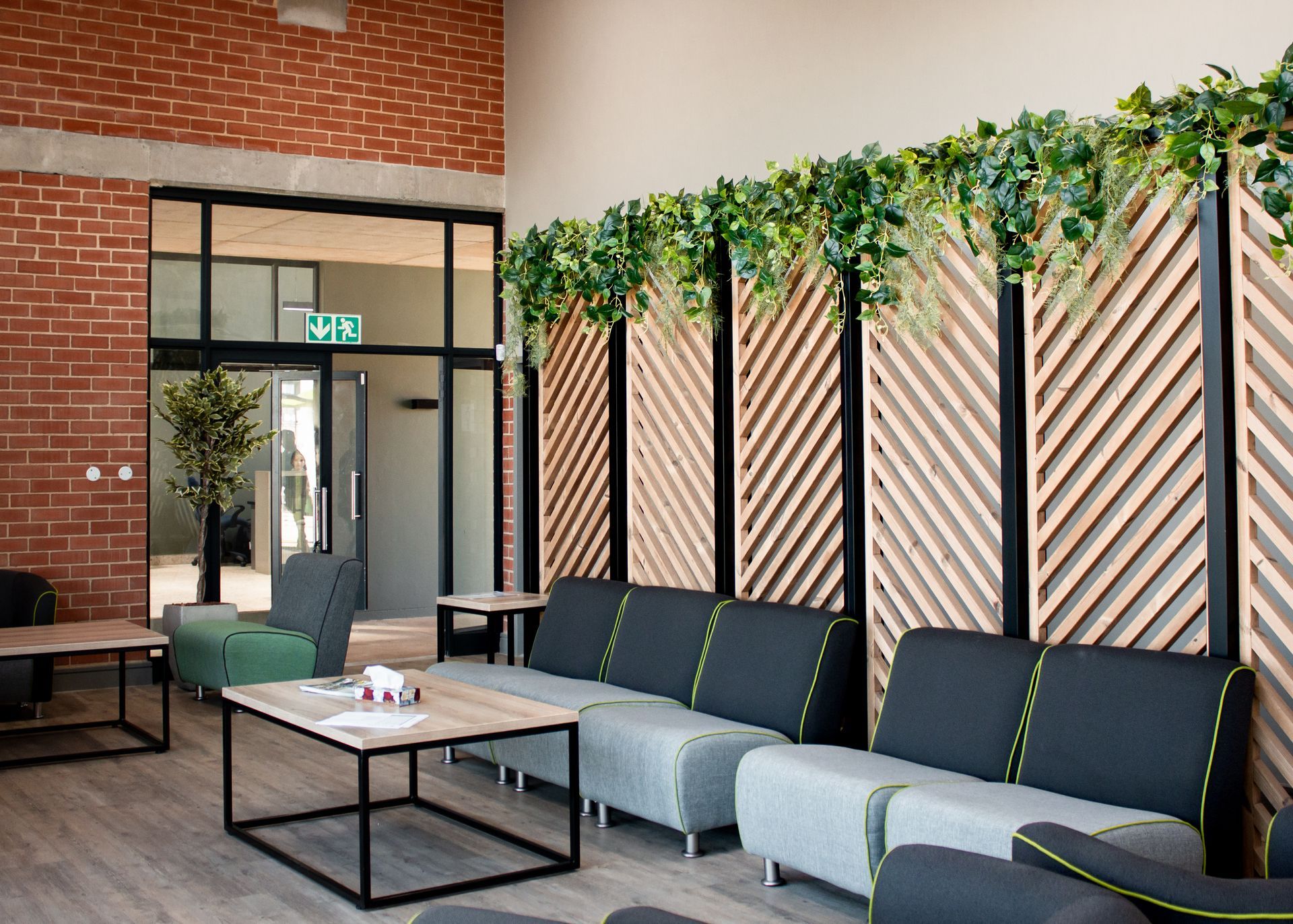 A living room with a lot of furniture and a brick wall.