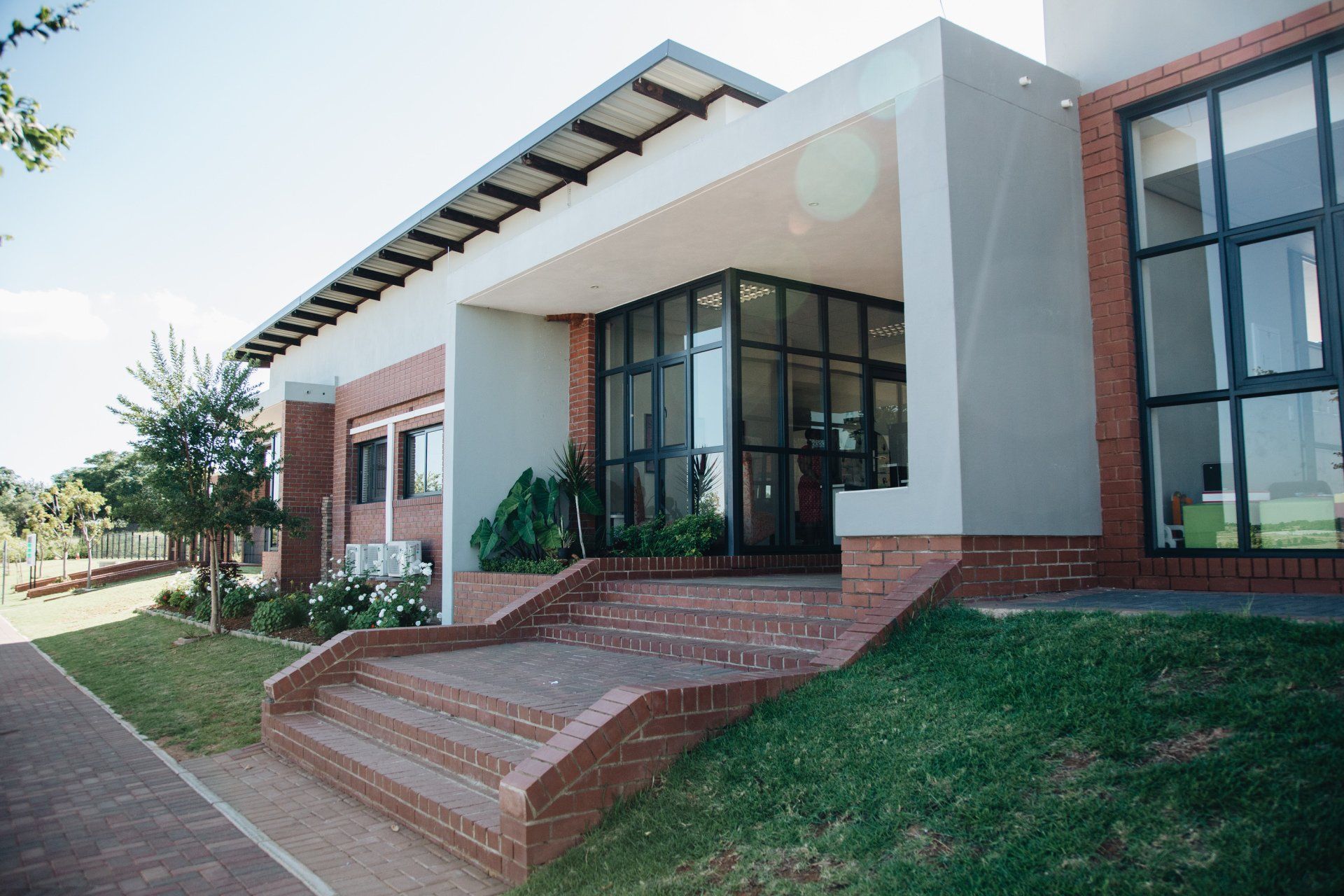 A large building with a lot of windows and stairs leading up to it.