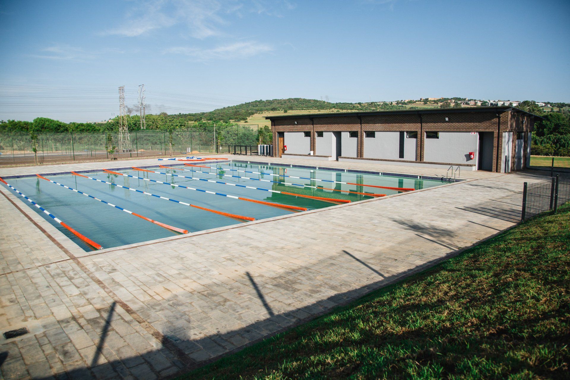 A large swimming pool with a building in the background.