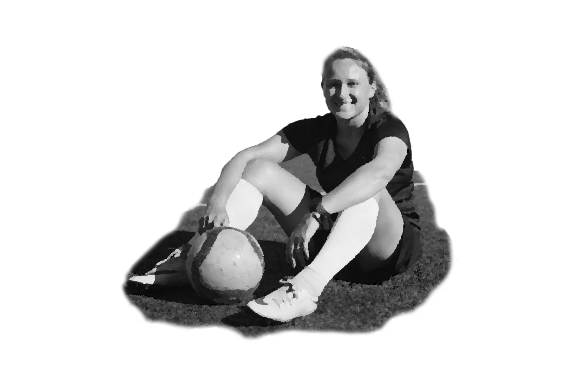 A woman is sitting on the grass with a soccer ball