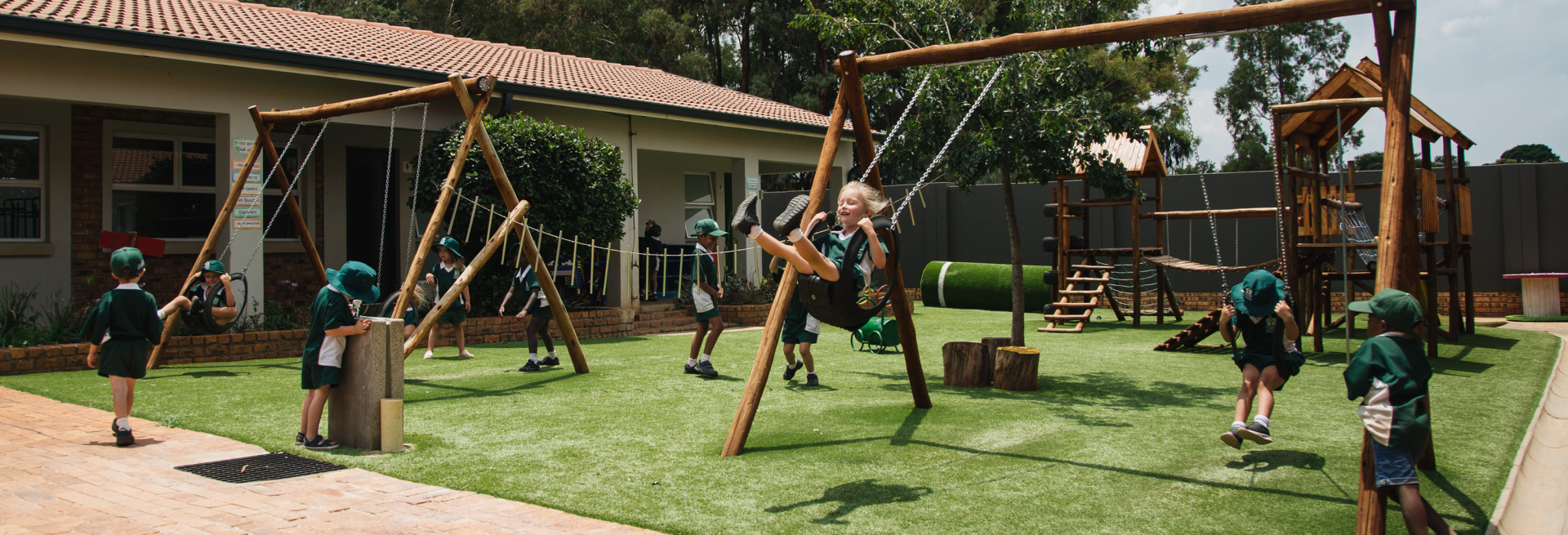 A group of children are playing on swings in a playground.