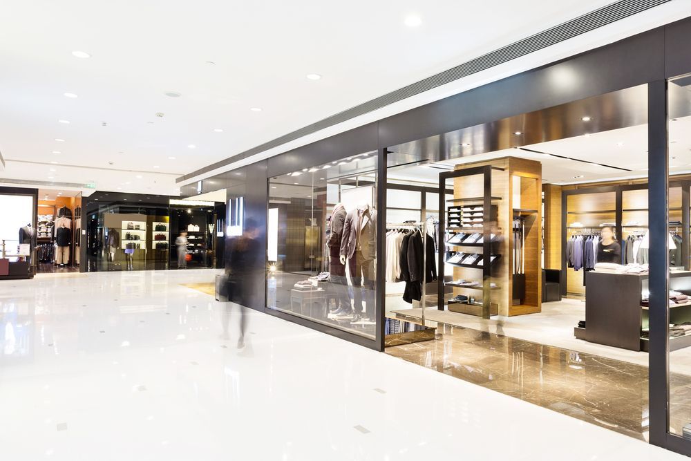 A Blurry Picture of A Clothing Store in A Shopping Mall — Thomas Croker Constructions In Myrtleville, NSW