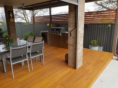 A wooden deck with a table and chairs and a grill. — Thomas Croker Constructions In Myrtleville, NSW