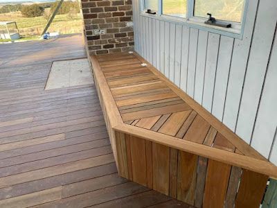 A wooden bench on a deck next to a window. — Thomas Croker Constructions In Myrtleville, NSW