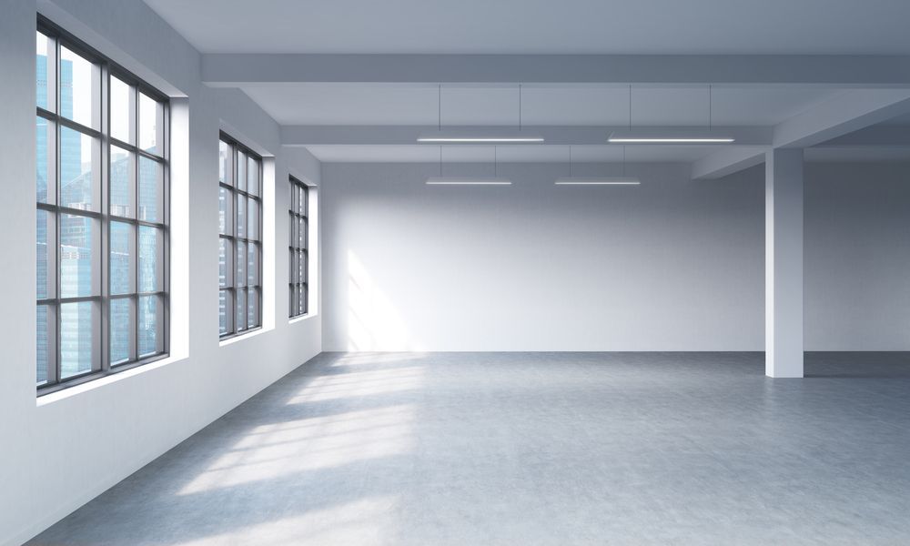 An Empty Room with A Lot of Windows and A Concrete Floor — Thomas Croker Constructions In Myrtleville, NSW