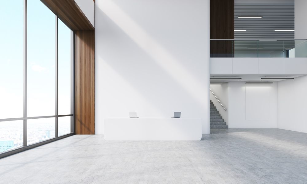 A Large Empty Room with A Lot of Windows and Stairs — Thomas Croker Constructions In Myrtleville, NSW