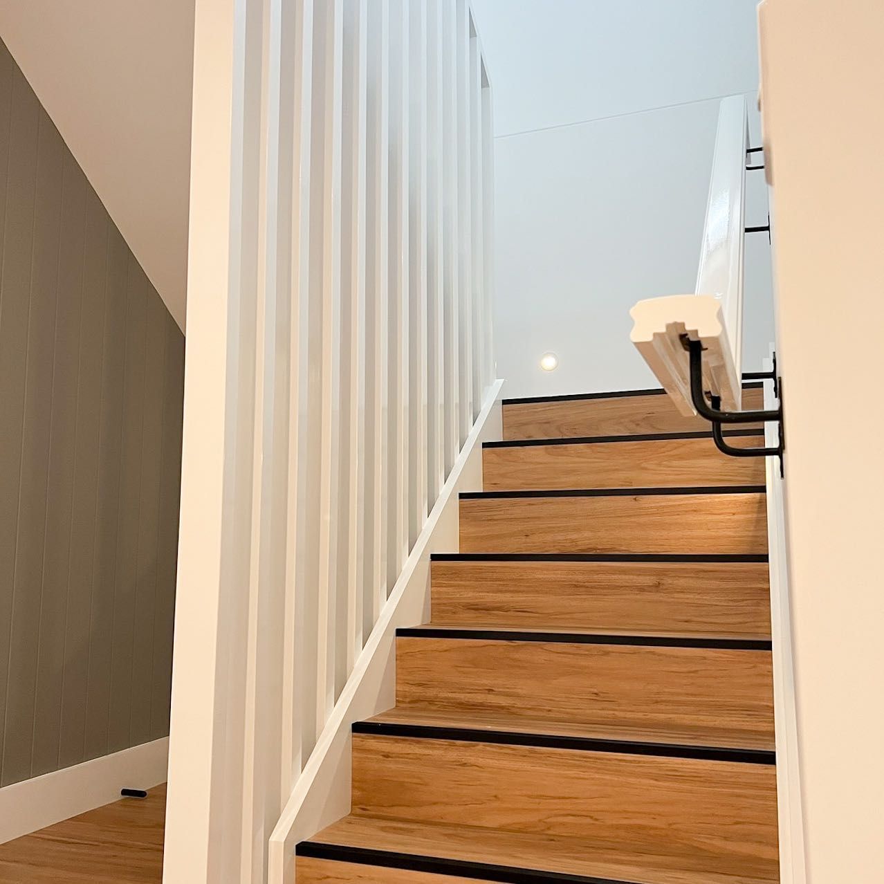 A staircase with wooden steps and a white railing — Thomas Croker Constructions In Myrtleville, NSW
