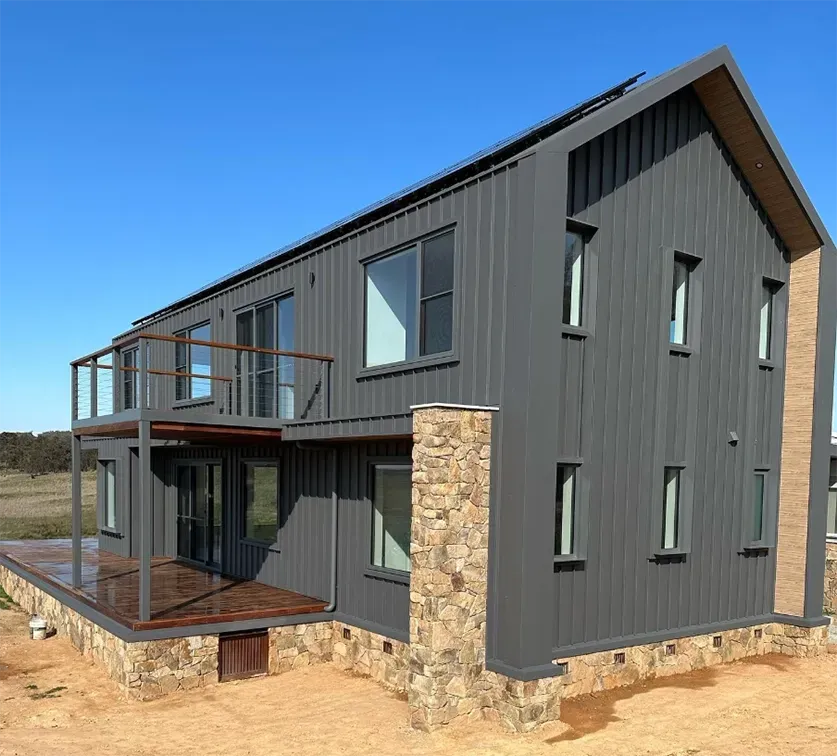 A large gray house with a stone pillar in front of it — Thomas Croker Constructions In Myrtleville, NSW