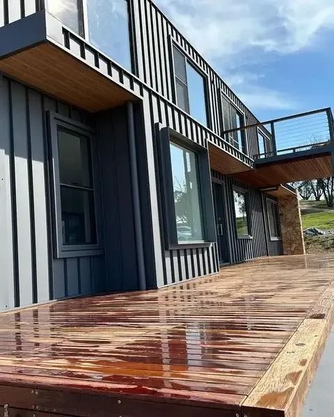 A large house with a wooden deck in front of it. — Thomas Croker Constructions In Myrtleville, NSW