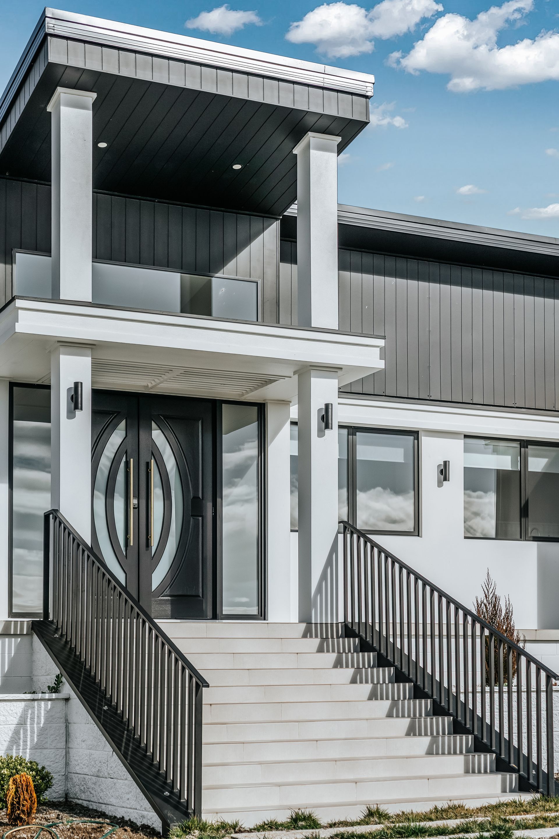 A House with A Wooden Door and Stairs Leading up To It — Thomas Croker Constructions In Myrtleville, NSW