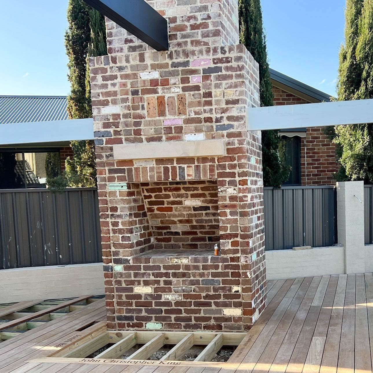 An Empty Room with A Ladder and Paint Buckets in Front of A Brick Wall — Thomas Croker Constructions In Myrtleville, NSW