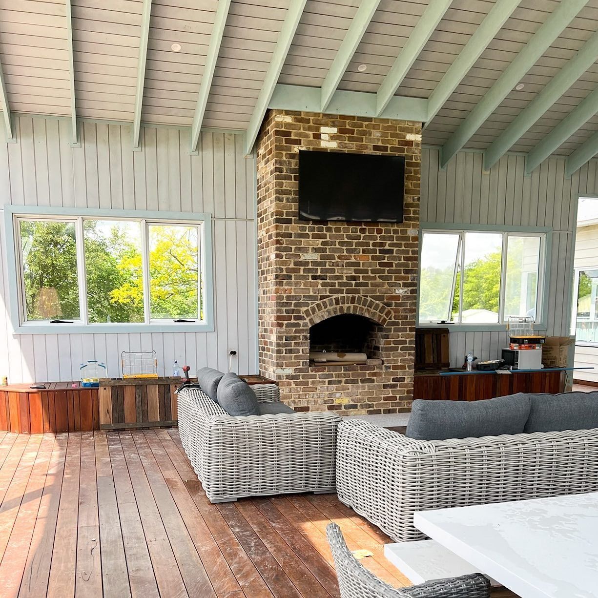 A Group of Construction Workers Are Working on The Roof of A Building — Thomas Croker Constructions In Myrtleville, NSW