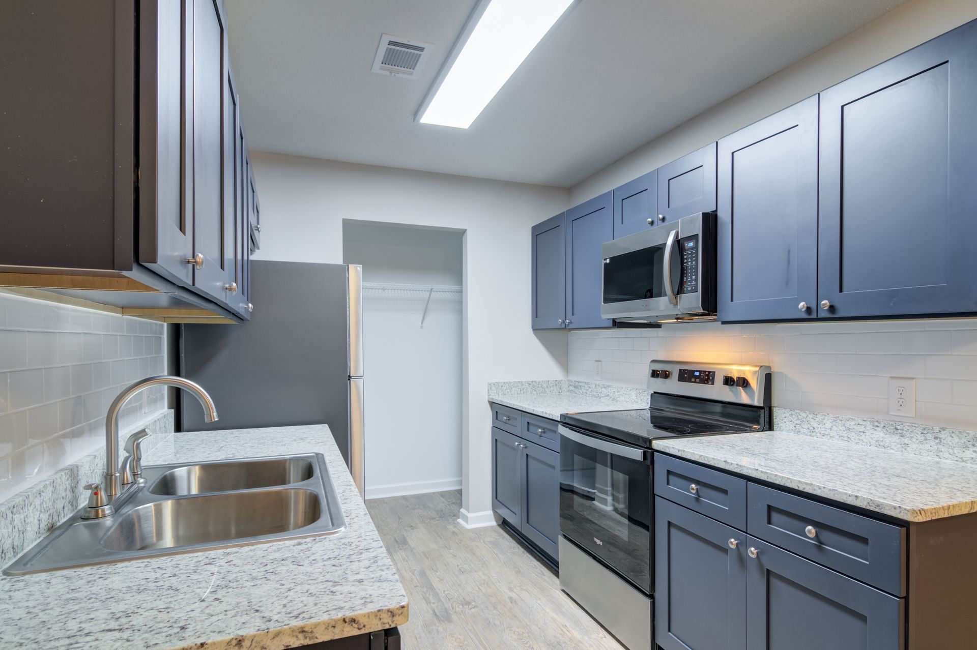 A bathroom with two sinks and a large mirror.