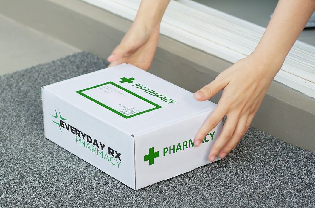 A person is holding a box that says pharmacy on it