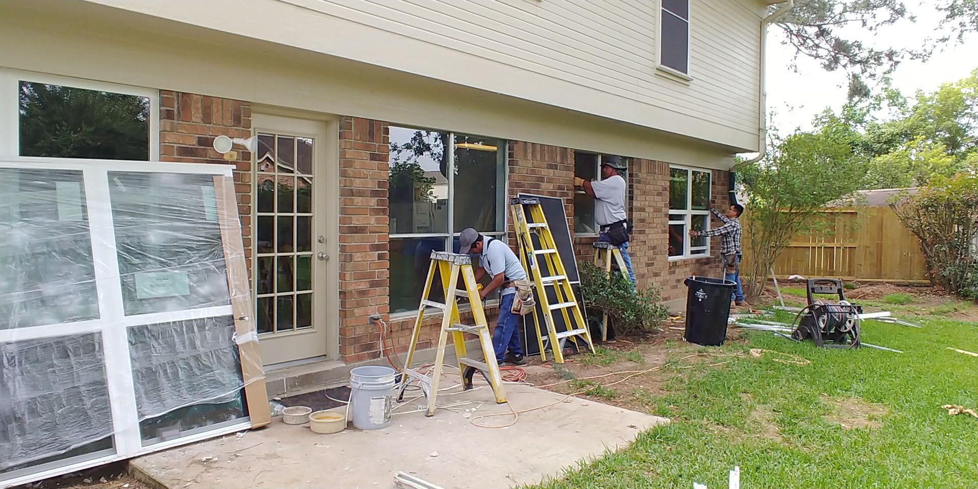 Inspector examining window on a house, holding clipboard and pen, outside. Man inspecting a house window, holding clipboard and pen, outside with siding.