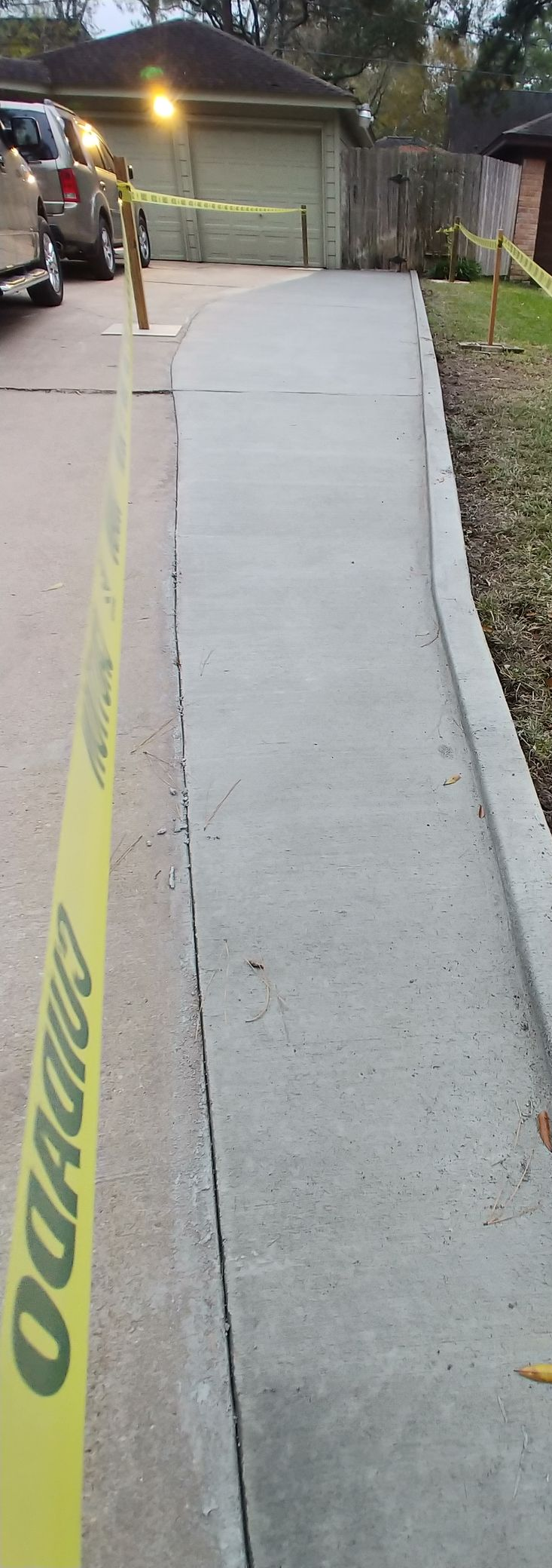 Square stone pavers set in green grass, creating a meandering pathway.
