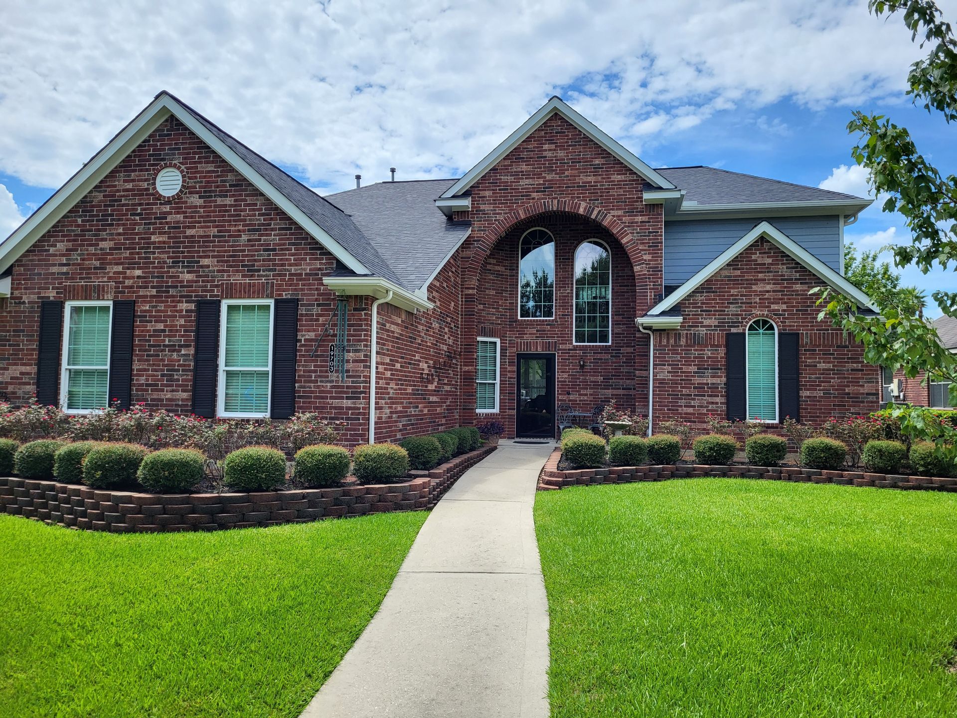 Person in blue overalls measuring a window frame with a yellow tape measure, indoor setting. Person in blue overalls measuring a window frame with a yellow tape measure, indoor setting.