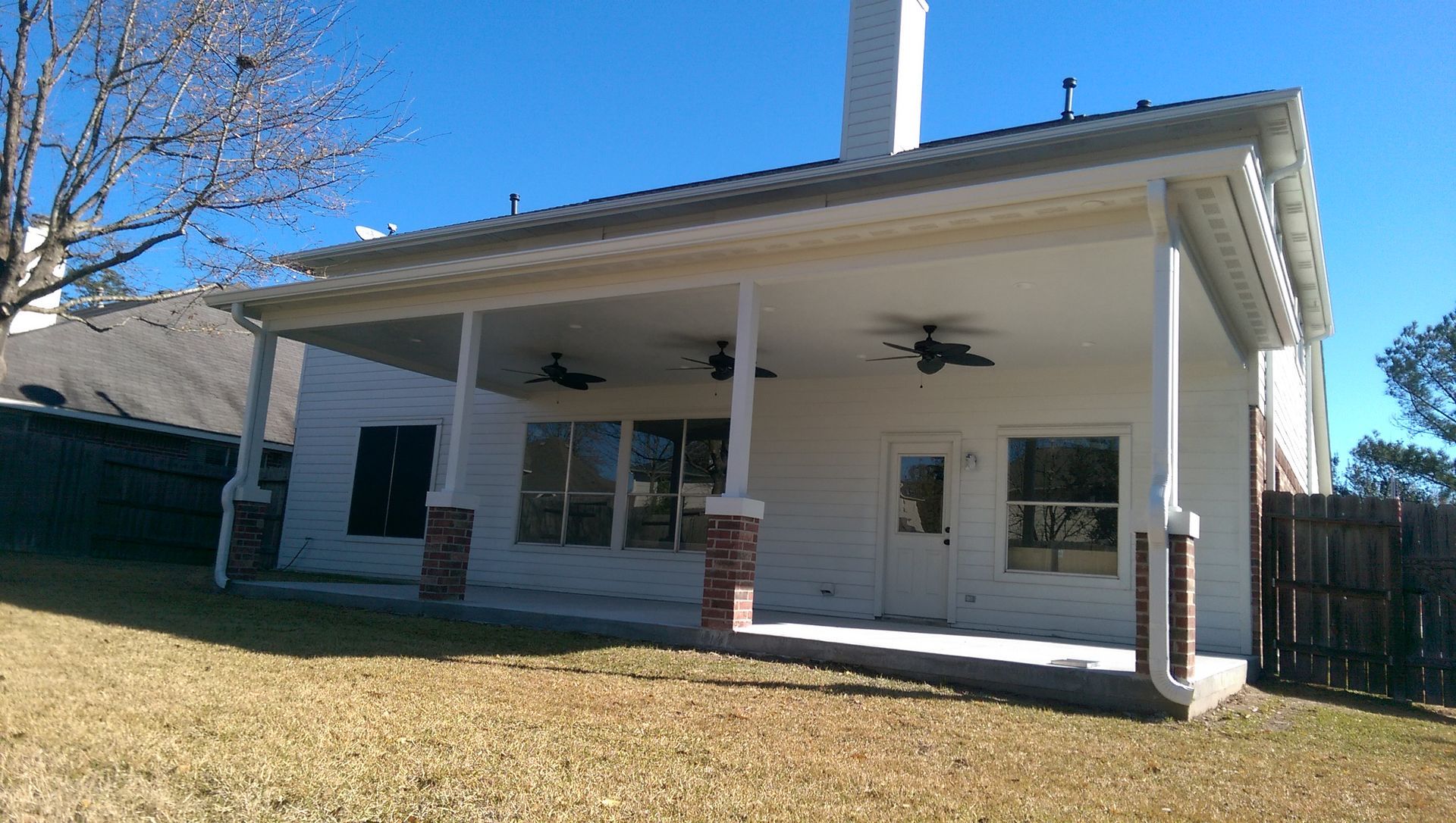 Outdoor patio with fire pit and Adirondack chairs, near a pool with a slide.